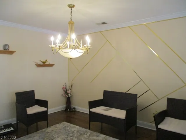 a view of a livingroom with furniture and chandelier