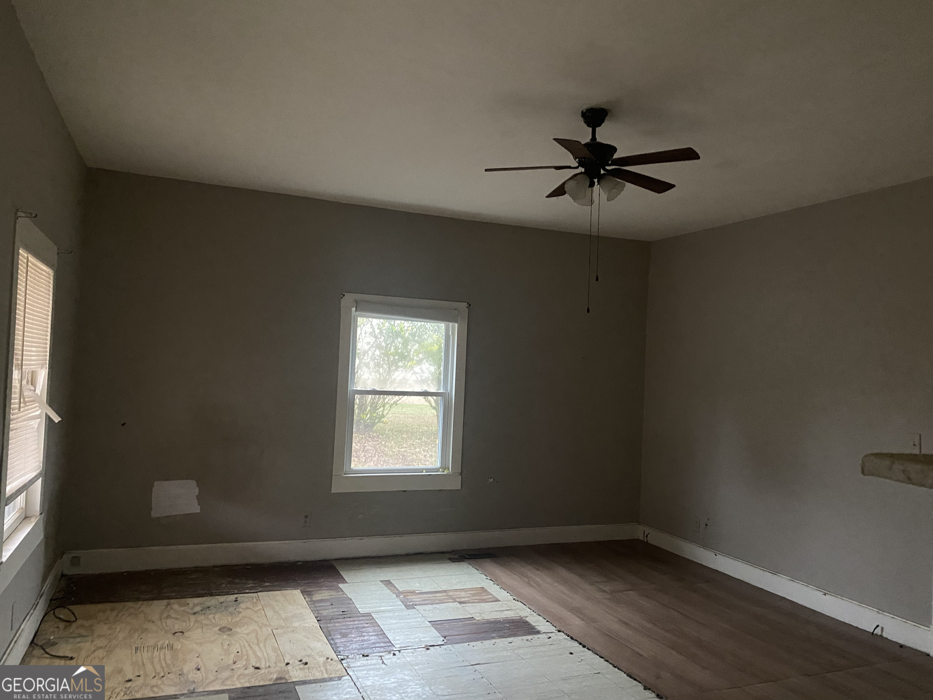 195 7th Street Trion, GA 30753 - Photo 3 of 10 an empty room with windows and fan