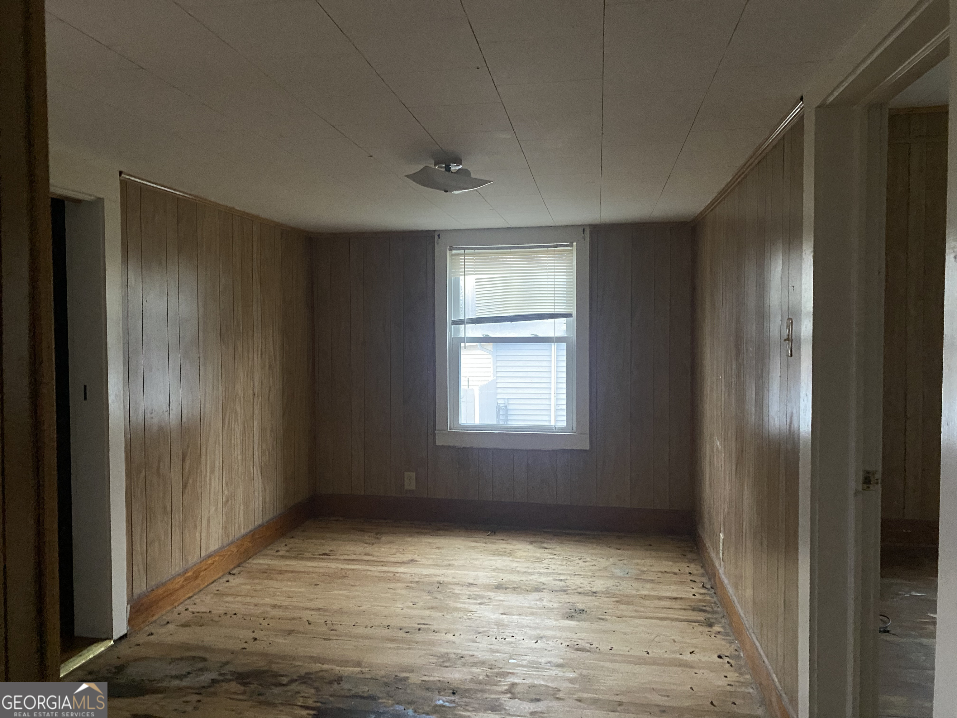 195 7th Street Trion, GA 30753 - Photo 5 of 10 a view of an empty room with wooden floor and a window