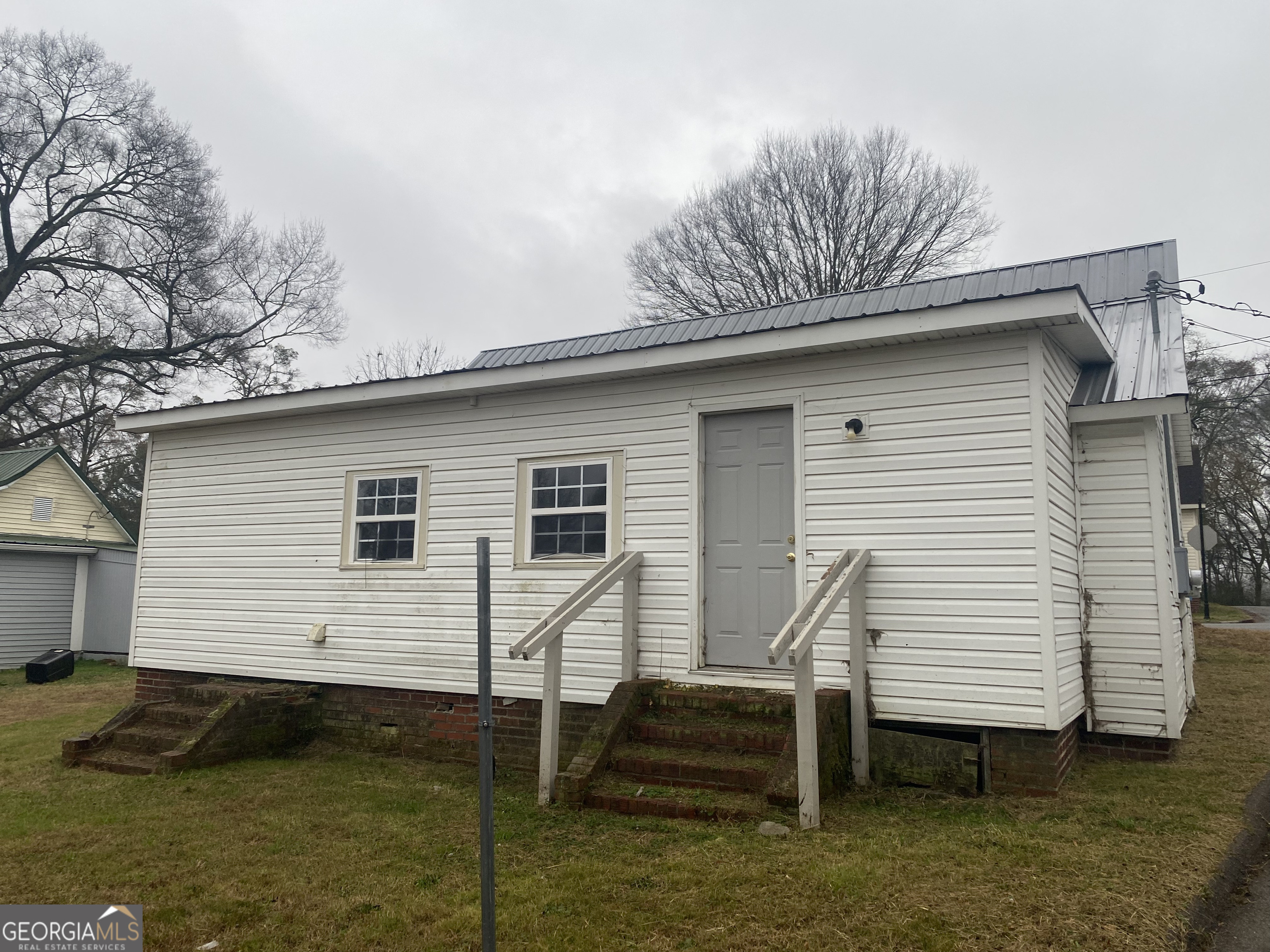 195 7th Street Trion, GA 30753 - Photo 10 of 10 a view of a white house with a yard and couches chairs