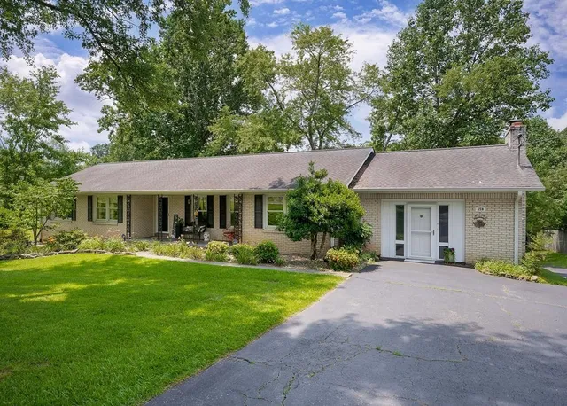 a front view of a house with garden and porch