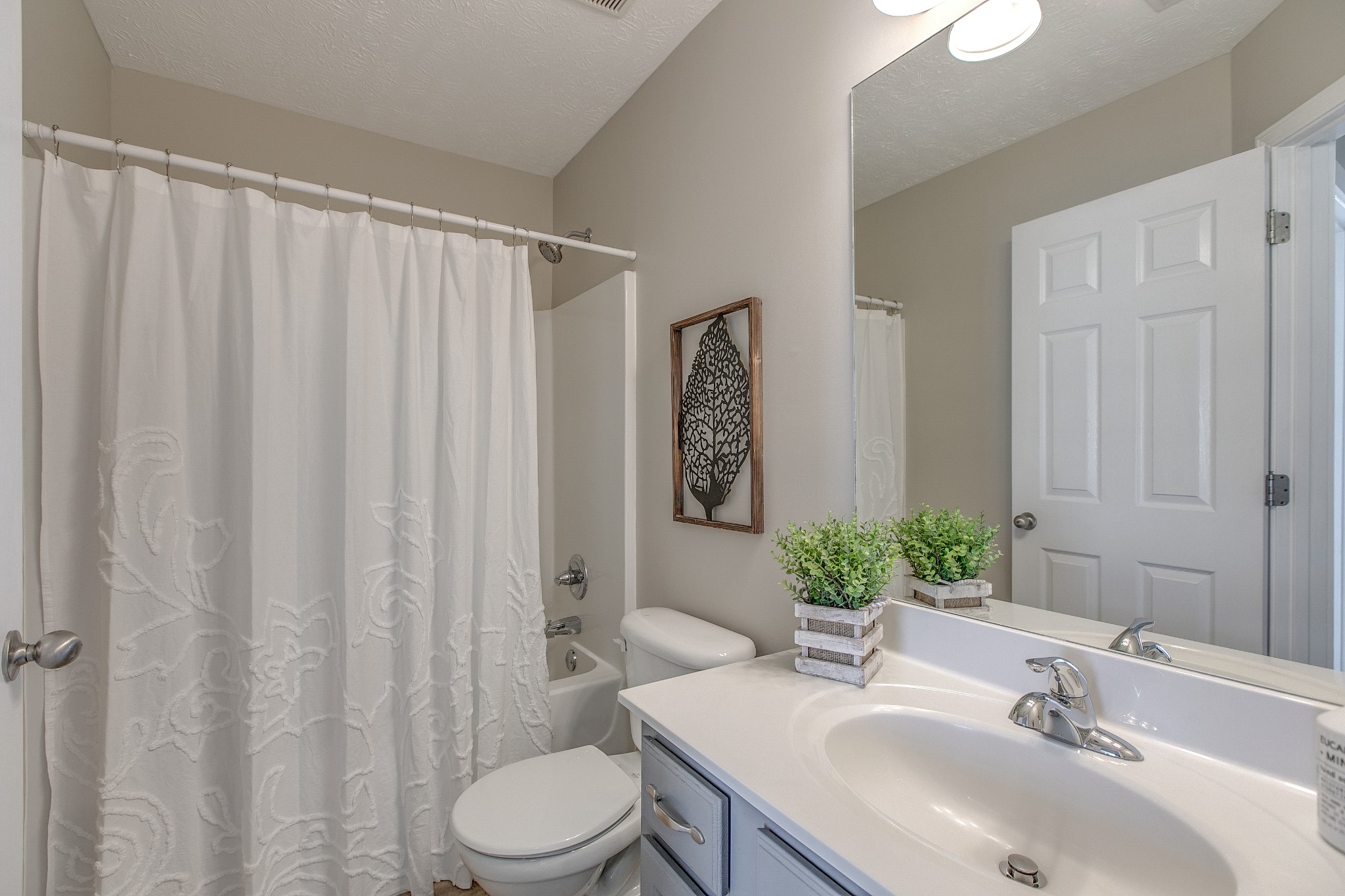 1025 Maxfli Drive Murfreesboro, TN 37129 - Photo 22 of 42 a bathroom with a sink a toilet and shower curtain