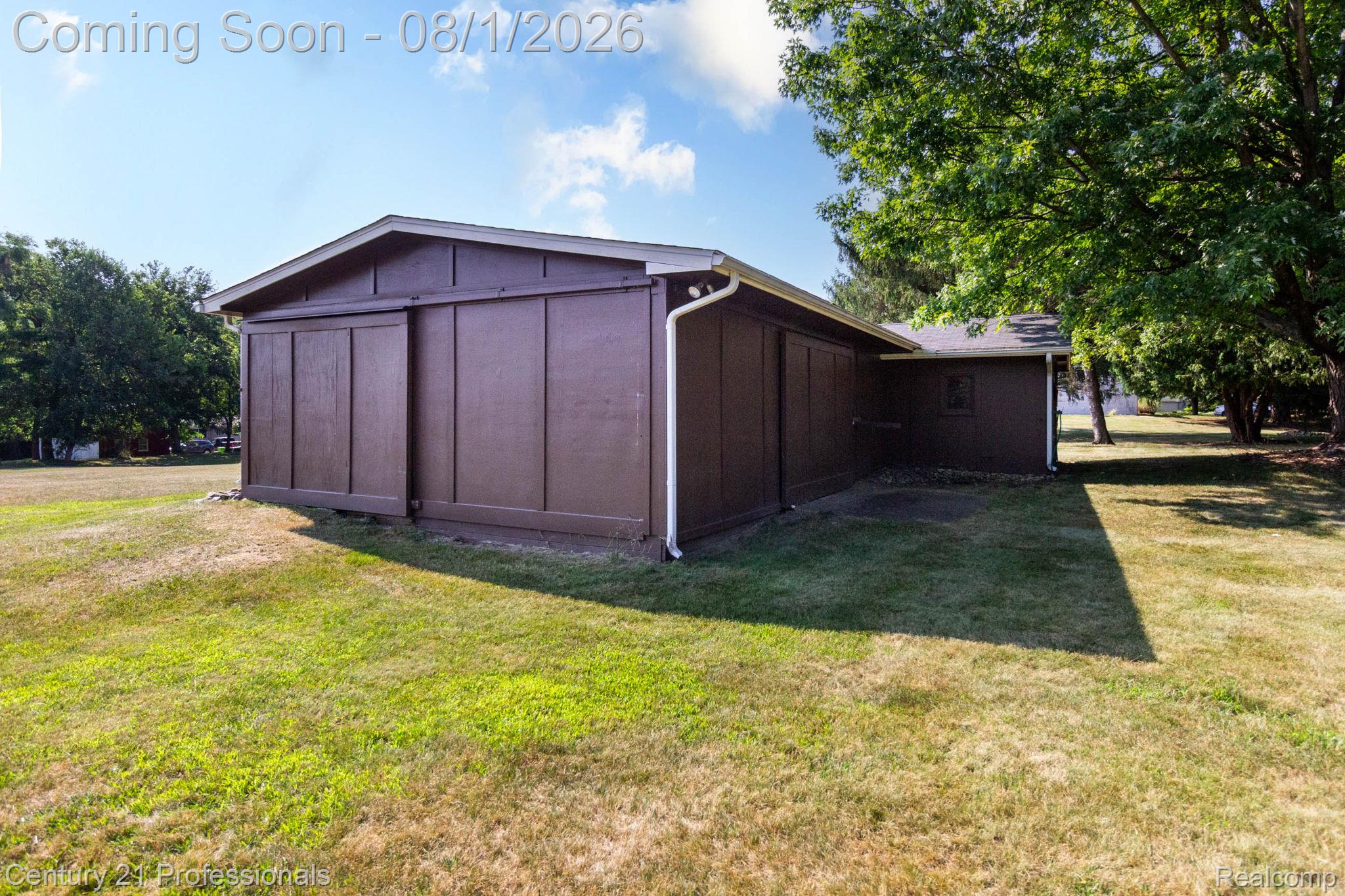 1365 East Buell Road Rochester, MI 48306 - Photo 37 of 56 Detached auxiliary building with brown vertical panel siding and a white fascia
