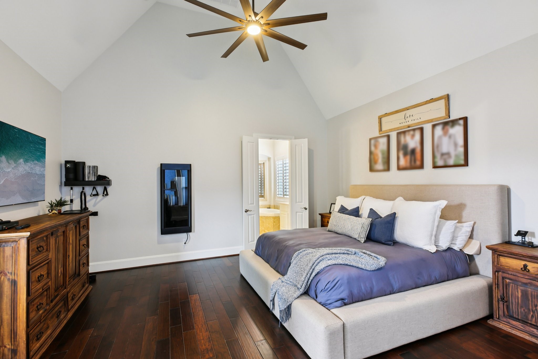 27914 Arden Trail Spring, TX 77386 - Photo 24 of 49 Spacious and inviting master bedroom featuring soaring vaulted ceilings, rich hardwood floors, and a stylish modern fan.