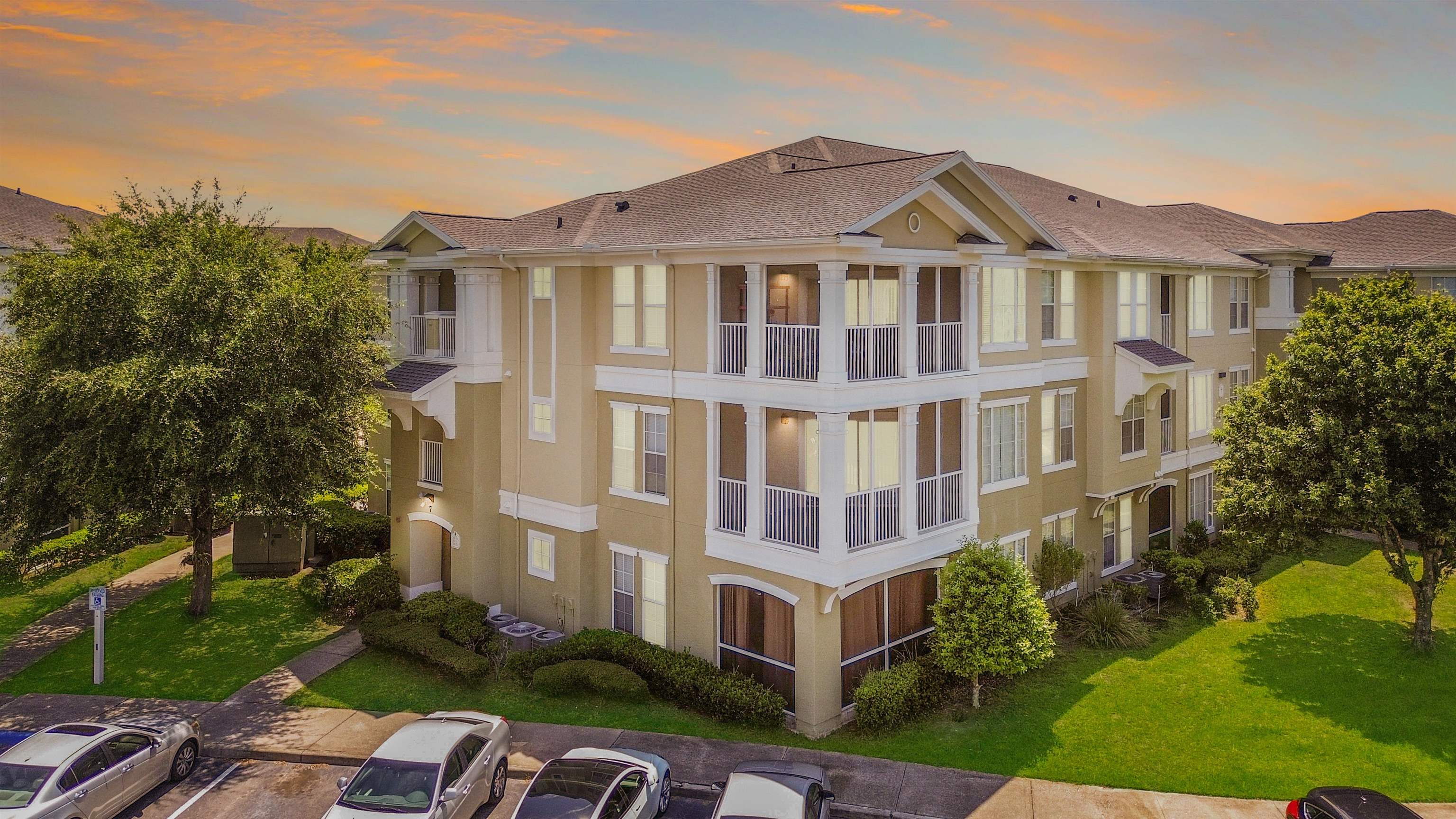8290 Gate Parkway, Unit 709 Jacksonville, FL 32216 - Photo 1 of 30 a front view of a residential apartment building with a yard
