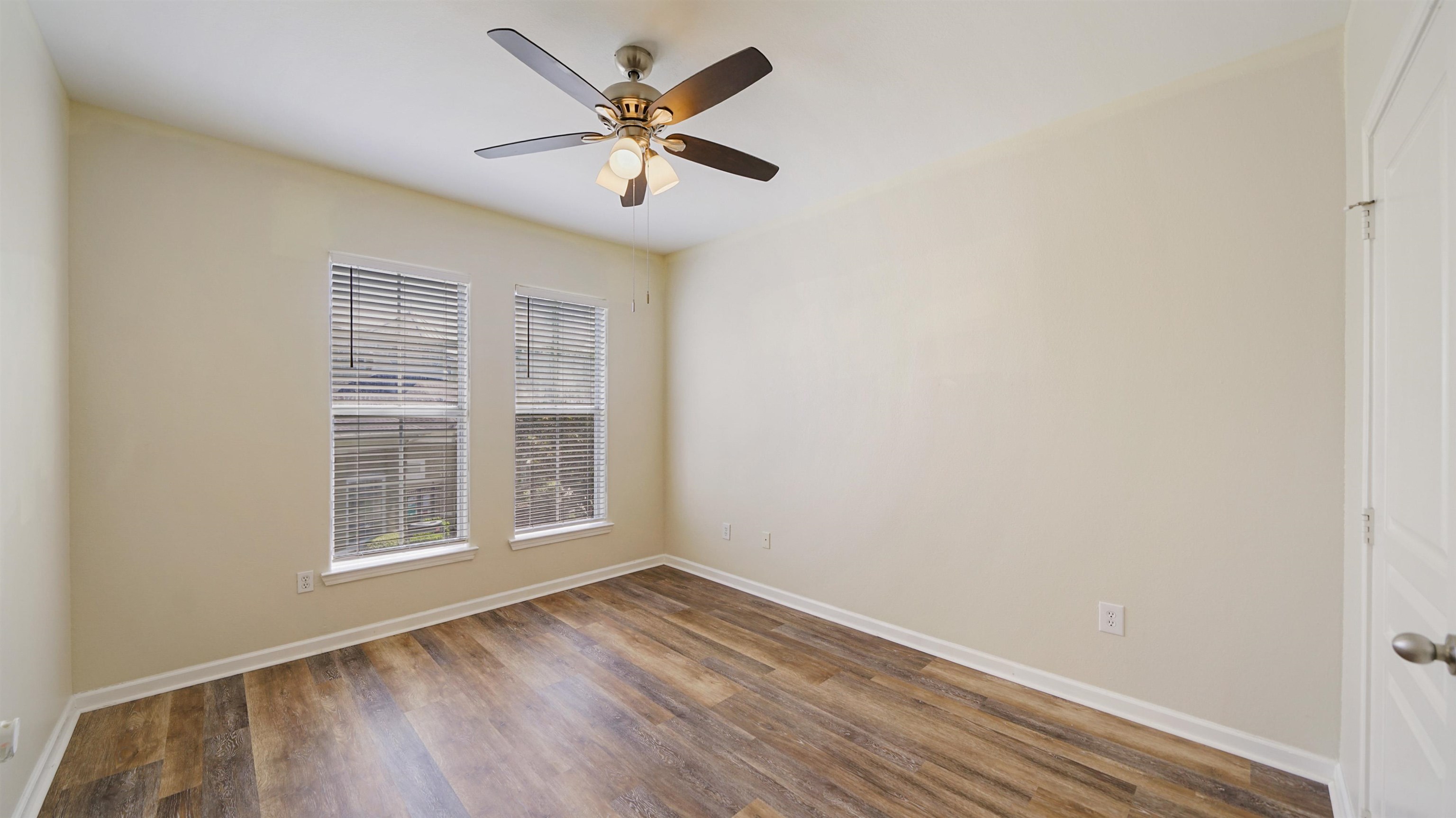 8290 Gate Parkway, Unit 709 Jacksonville, FL 32216 - Photo 16 of 30 an empty room with wooden floor and windows