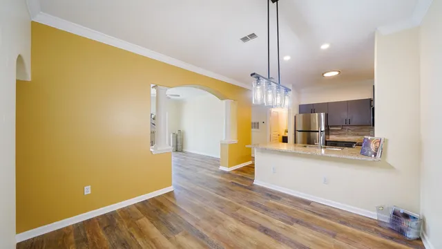 a view of a kitchen with a sink and a refrigerator