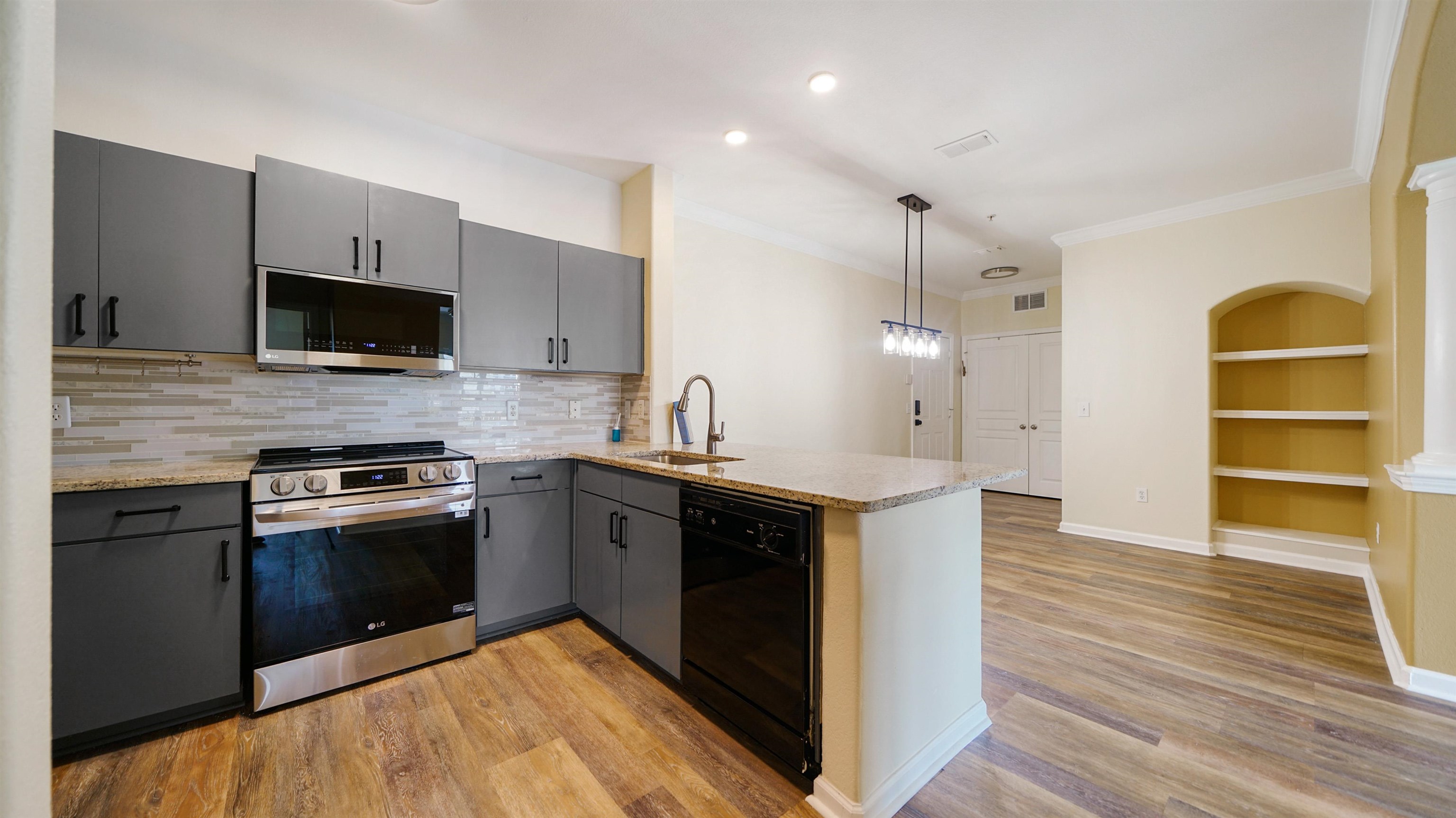 8290 Gate Parkway, Unit 709 Jacksonville, FL 32216 - Photo 4 of 30 a kitchen with stainless steel appliances granite countertop a stove and a refrigerator