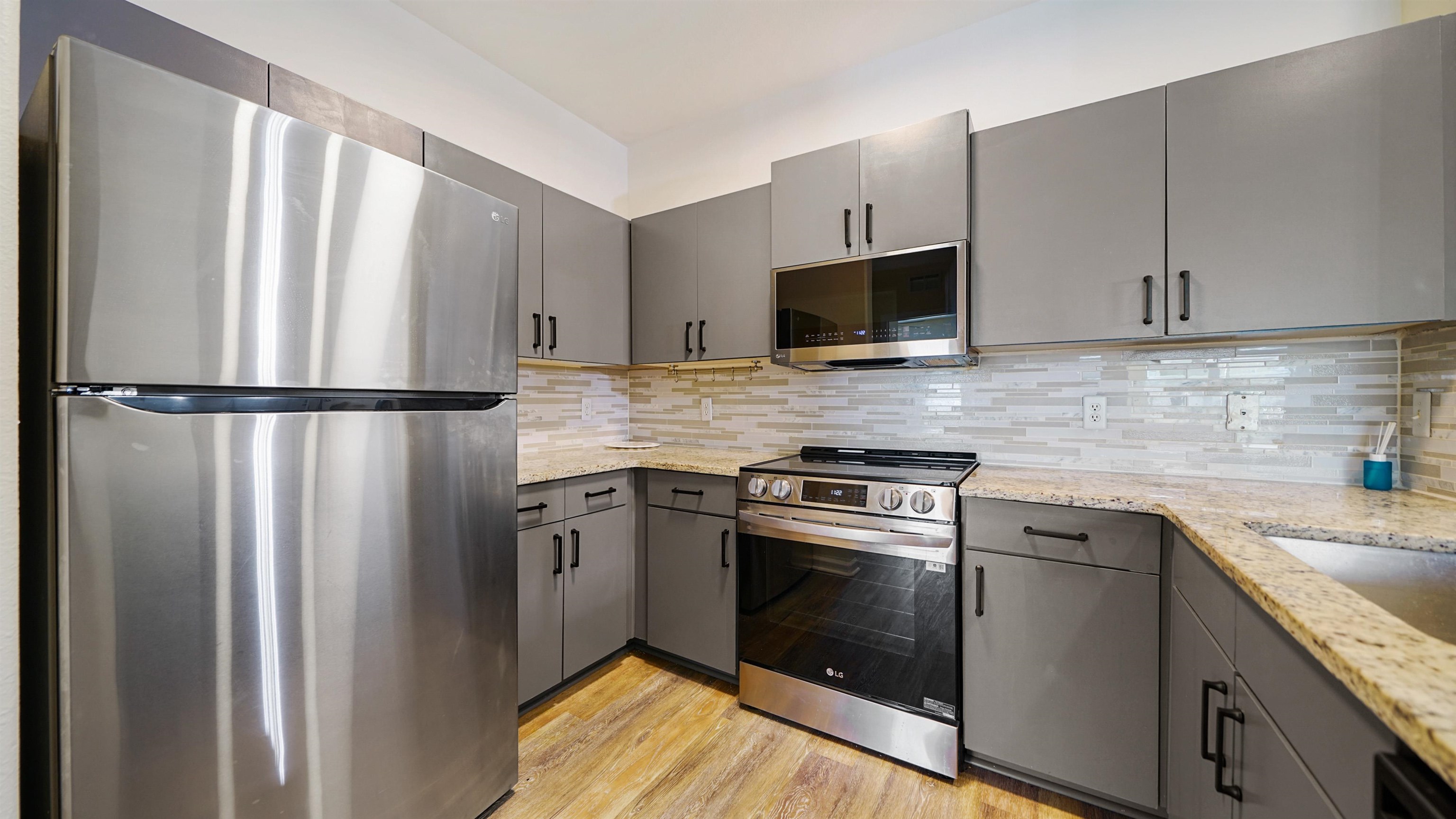8290 Gate Parkway, Unit 709 Jacksonville, FL 32216 - Photo 5 of 30 a kitchen with stainless steel appliances a refrigerator stove and microwave