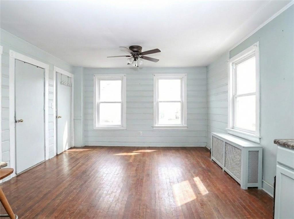 636 Holmdel Road Hazlet, NJ 07730 - Photo 18 of 47 an empty room with wooden floor and windows