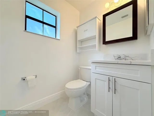 a kitchen with granite countertop white cabinets white stainless steel appliances and sink