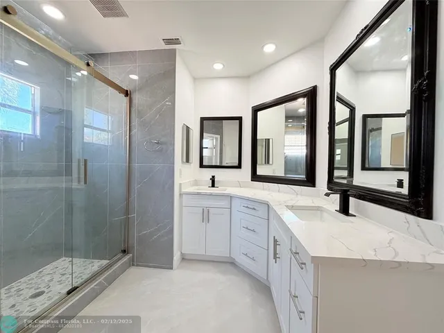 a bathroom with a sink mirror vanity and toilet