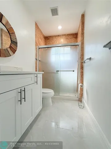 a view of a yard with plants and trees