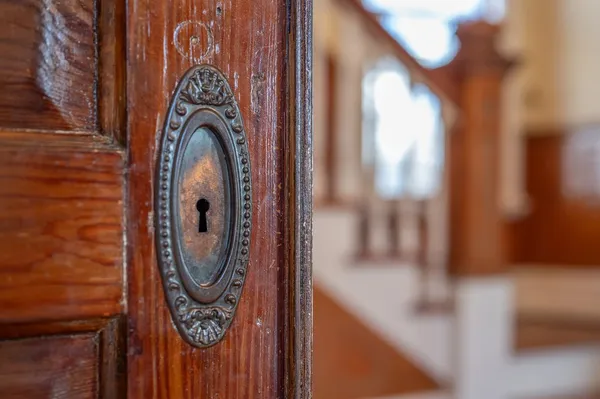 a close view of a door with wooden wall