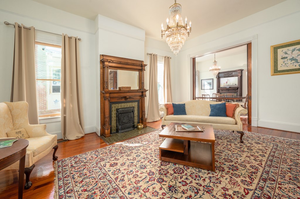 715 Broadway Columbus, GA 31901 - Photo 19 of 75 a living room with furniture a fireplace and a chandelier