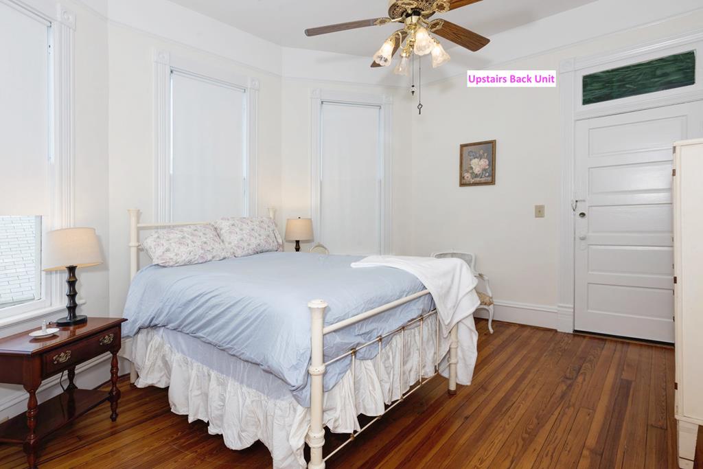 715 Broadway Columbus, GA 31901 - Photo 61 of 75 a bedroom with a bed and wooden floor