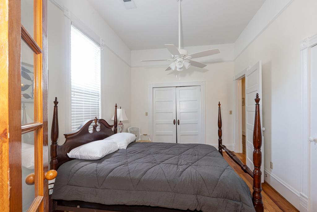 715 Broadway Columbus, GA 31901 - Photo 64 of 75 a bedroom with a bed and a chandelier