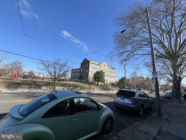 a view of cars parked on a sidewalk