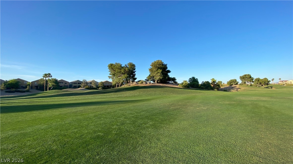 489 Foster Springs Road Las Vegas, NV 89148 - Photo 19 of 30 Green fairways stretch towards a community backdrop, offering serene golf course living.