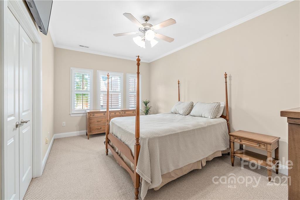 4617 Dabney Vigor Drive Charlotte, NC 28209 - Photo 12 of 23 a bed room with a bed and a chandelier