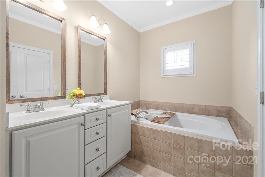 4617 Dabney Vigor Drive Charlotte, NC 28209 - Photo 14 of 23 a bathroom with a tub sink and mirror