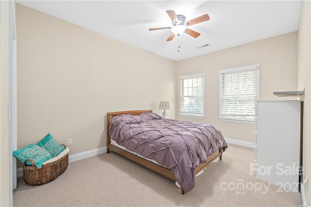 4617 Dabney Vigor Drive Charlotte, NC 28209 - Photo 17 of 23 a bedroom with a bed a window and a chandelier