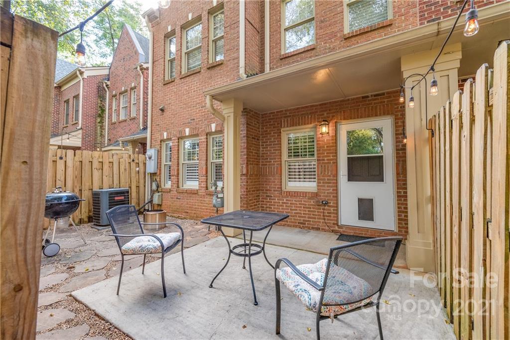 4617 Dabney Vigor Drive Charlotte, NC 28209 - Photo 19 of 23 a patio with table and chairs and potted plants