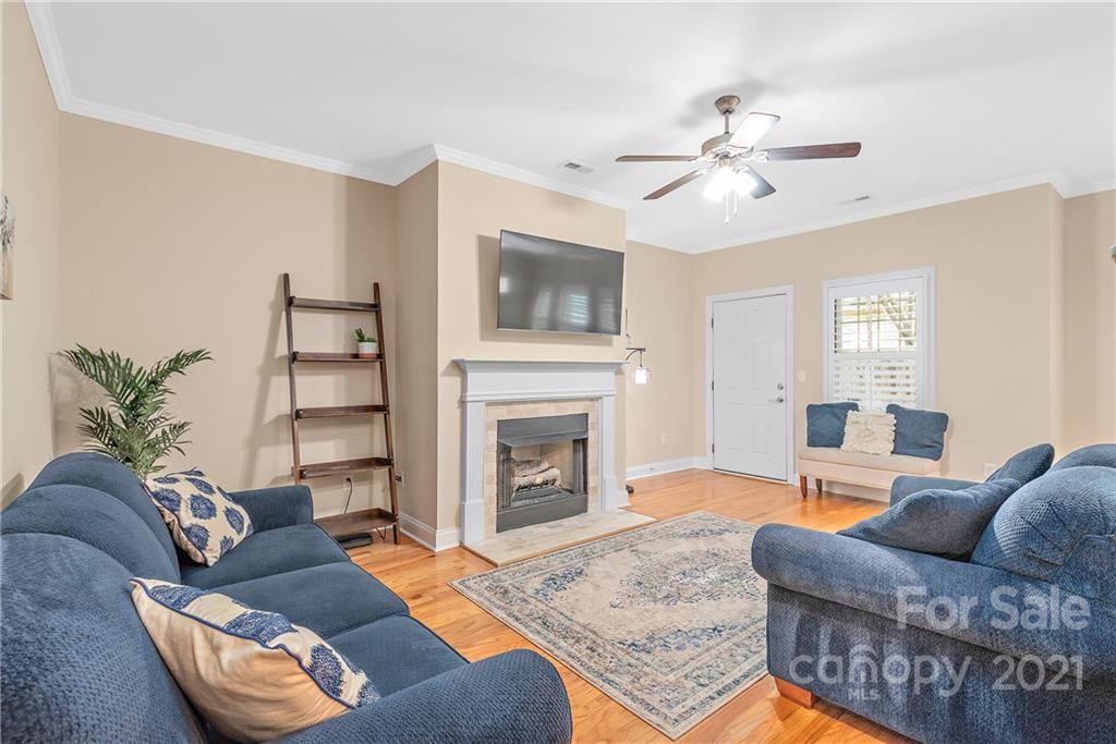 4617 Dabney Vigor Drive Charlotte, NC 28209 - Photo 5 of 23 a living room with furniture a fireplace and a flat screen tv