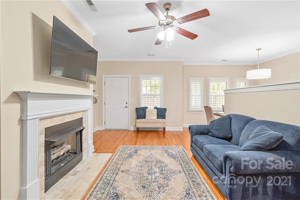 4617 Dabney Vigor Drive Charlotte, NC 28209 - Photo 6 of 23 a living room with furniture a fireplace and a flat screen tv