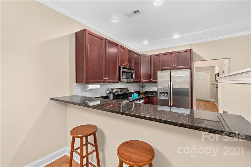 4617 Dabney Vigor Drive Charlotte, NC 28209 - Photo 9 of 23 a kitchen with stainless steel appliances granite countertop a sink stove and refrigerator