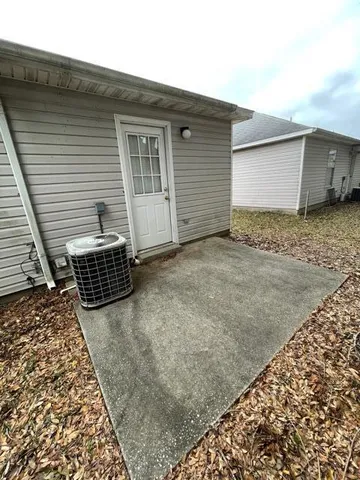 a view of a backyard with wooden fence