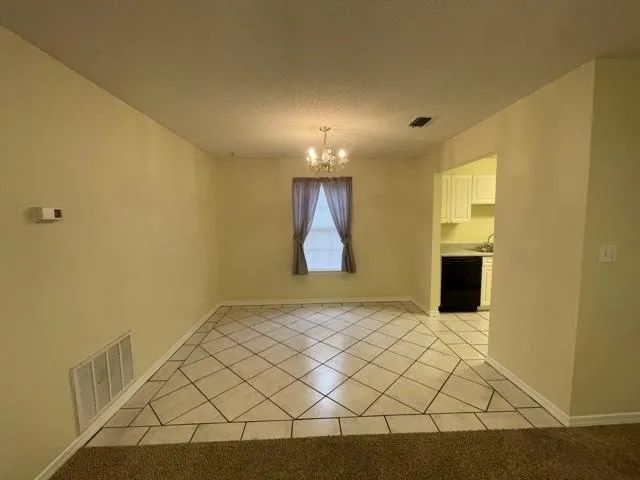 a view of a room with wooden floor and cabinet