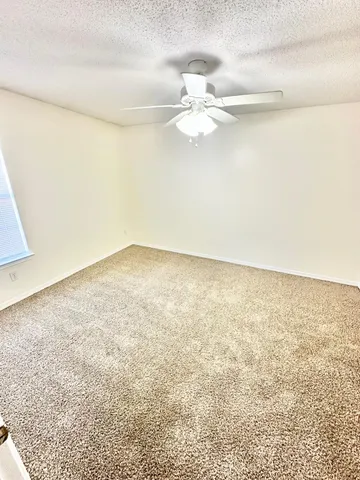 a bathroom with a granite countertop toilet and a sink