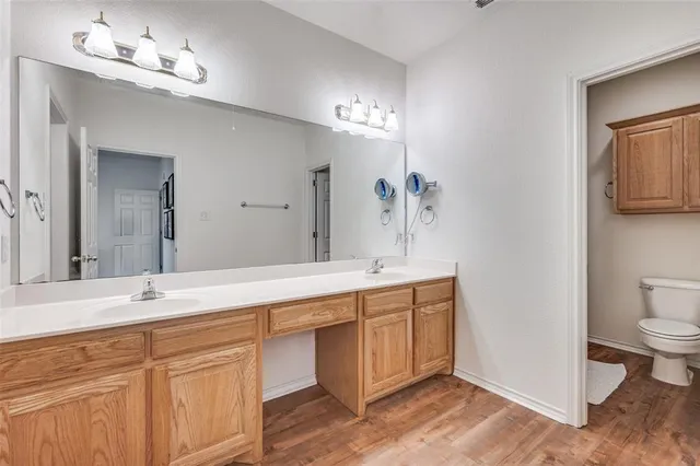 an empty room with windows and ceiling fan