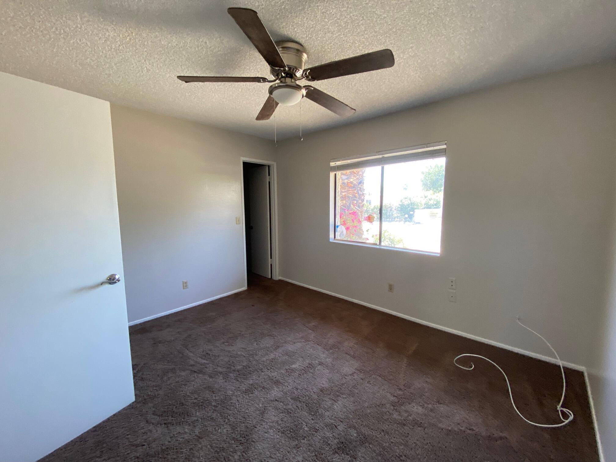 2120 Wayne Road Palm Springs, CA 92262 - Photo 15 of 21 an empty room with windows and fan