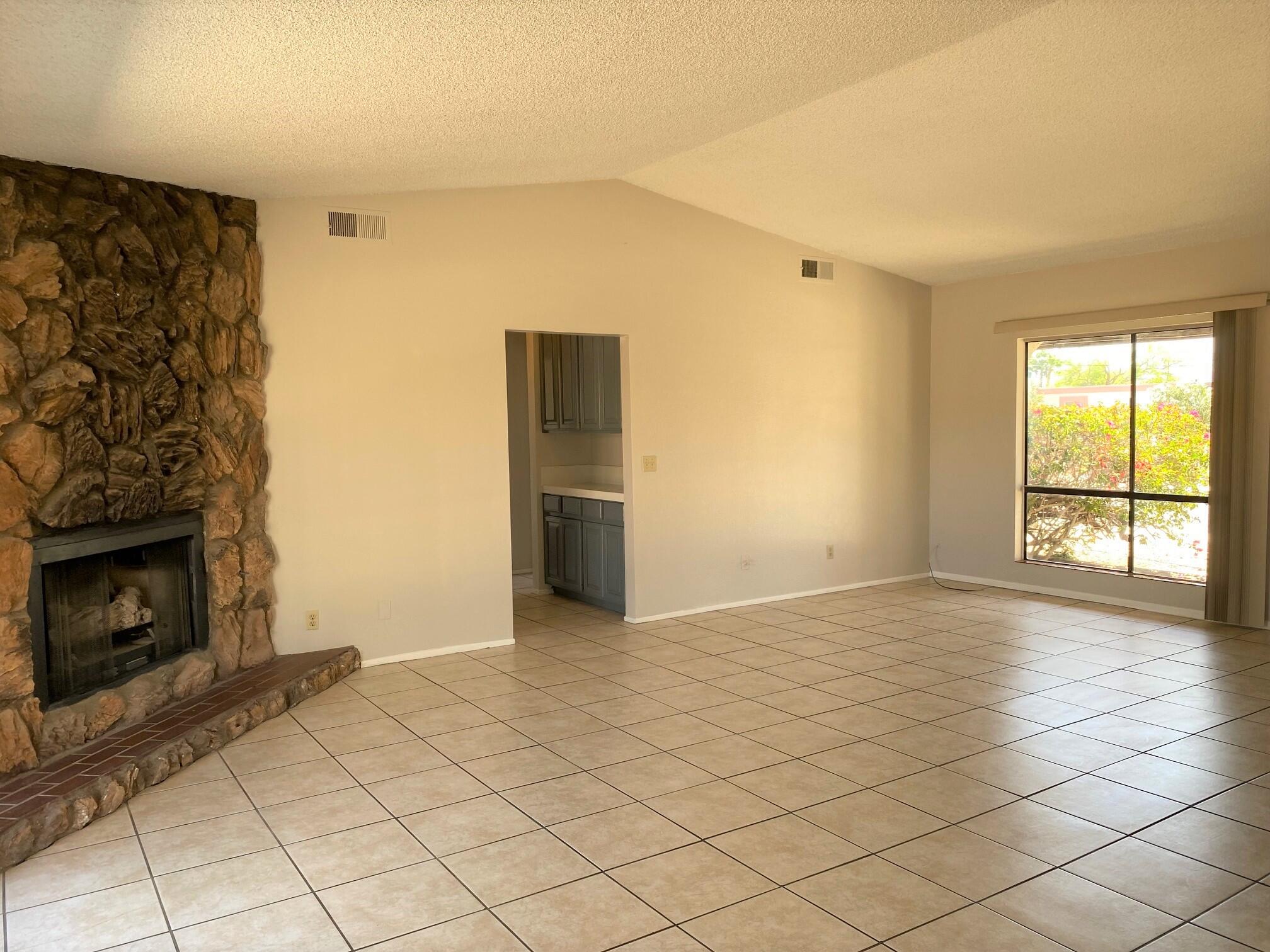 2120 Wayne Road Palm Springs, CA 92262 - Photo 5 of 21 a view of an empty room with a fireplace and a window