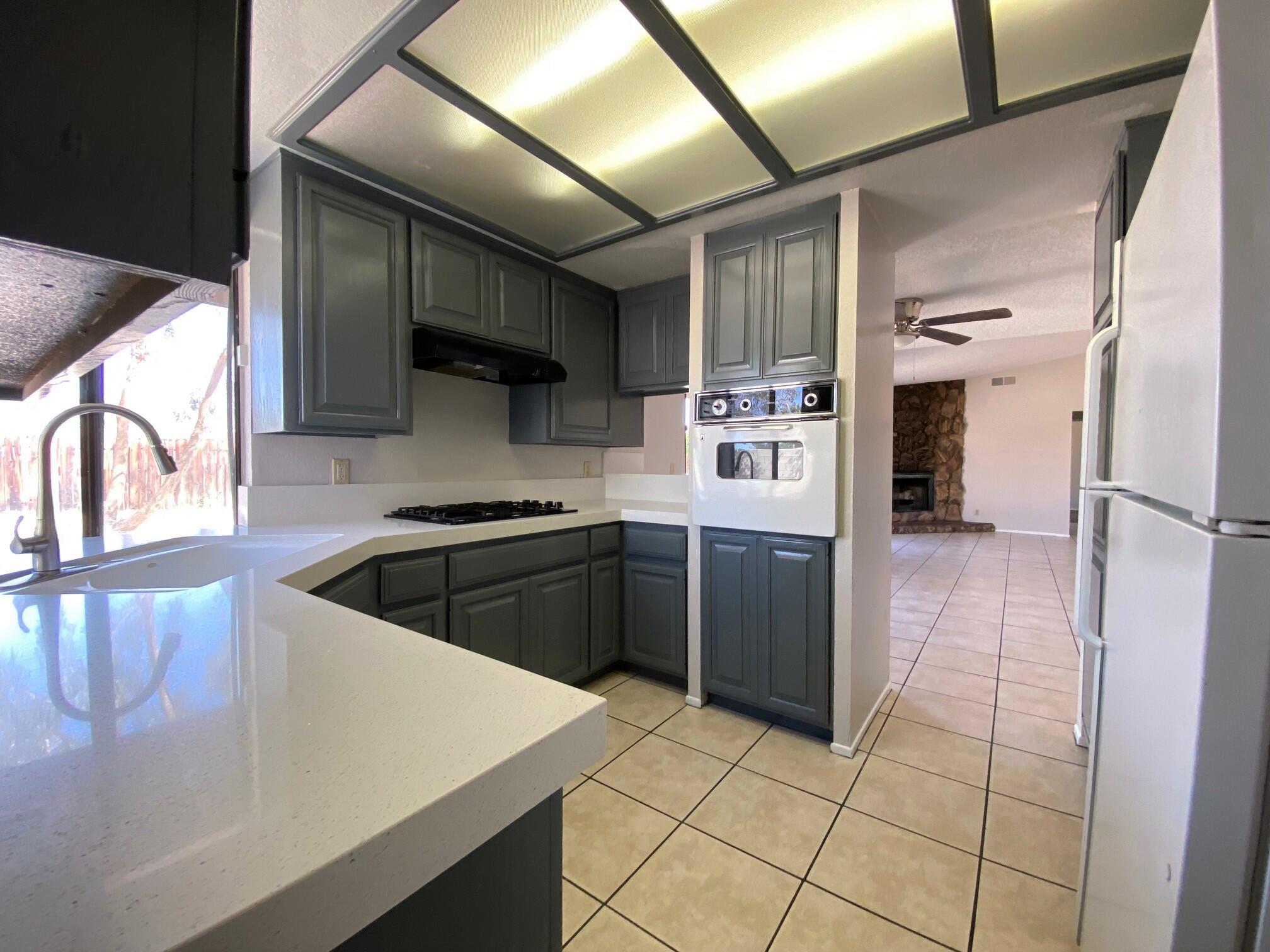 2120 Wayne Road Palm Springs, CA 92262 - Photo 6 of 21 a kitchen with a sink a stove and refrigerator