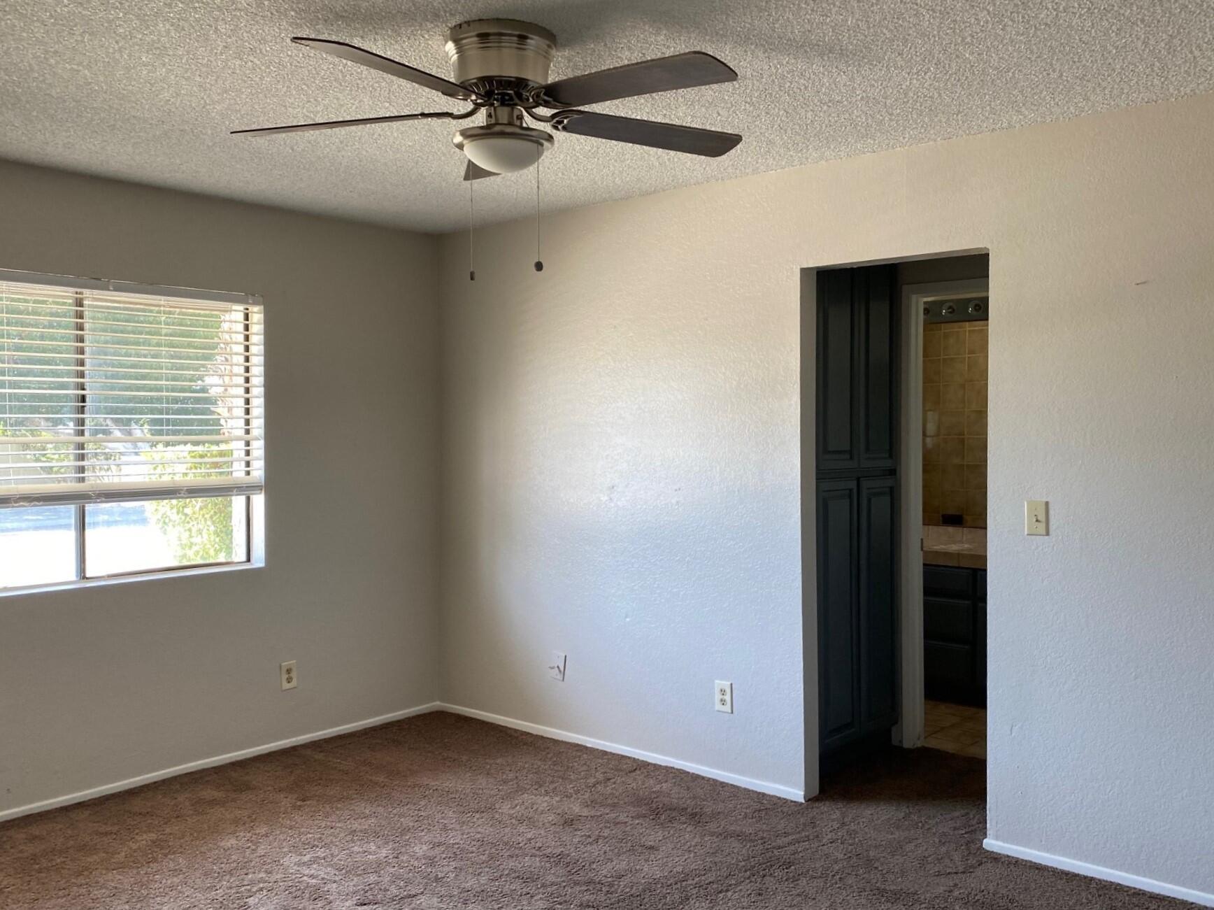 2120 Wayne Road Palm Springs, CA 92262 - Photo 10 of 21 an empty room with a window and a fan