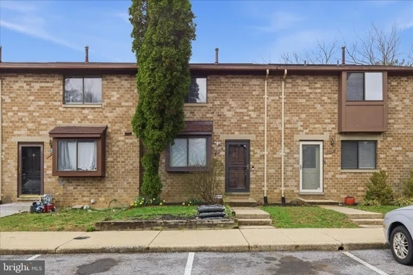 a view of a brick house with a yard