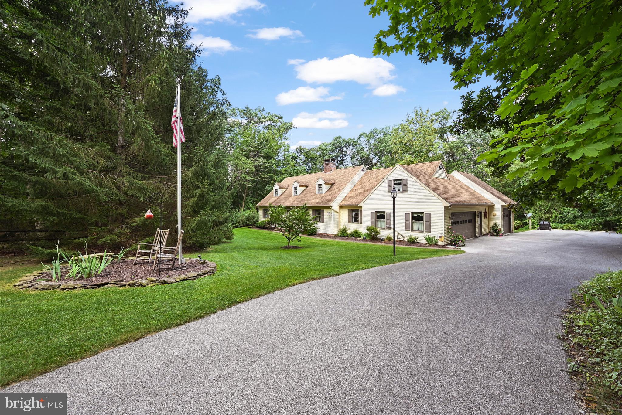 a view of a house with garden and trees