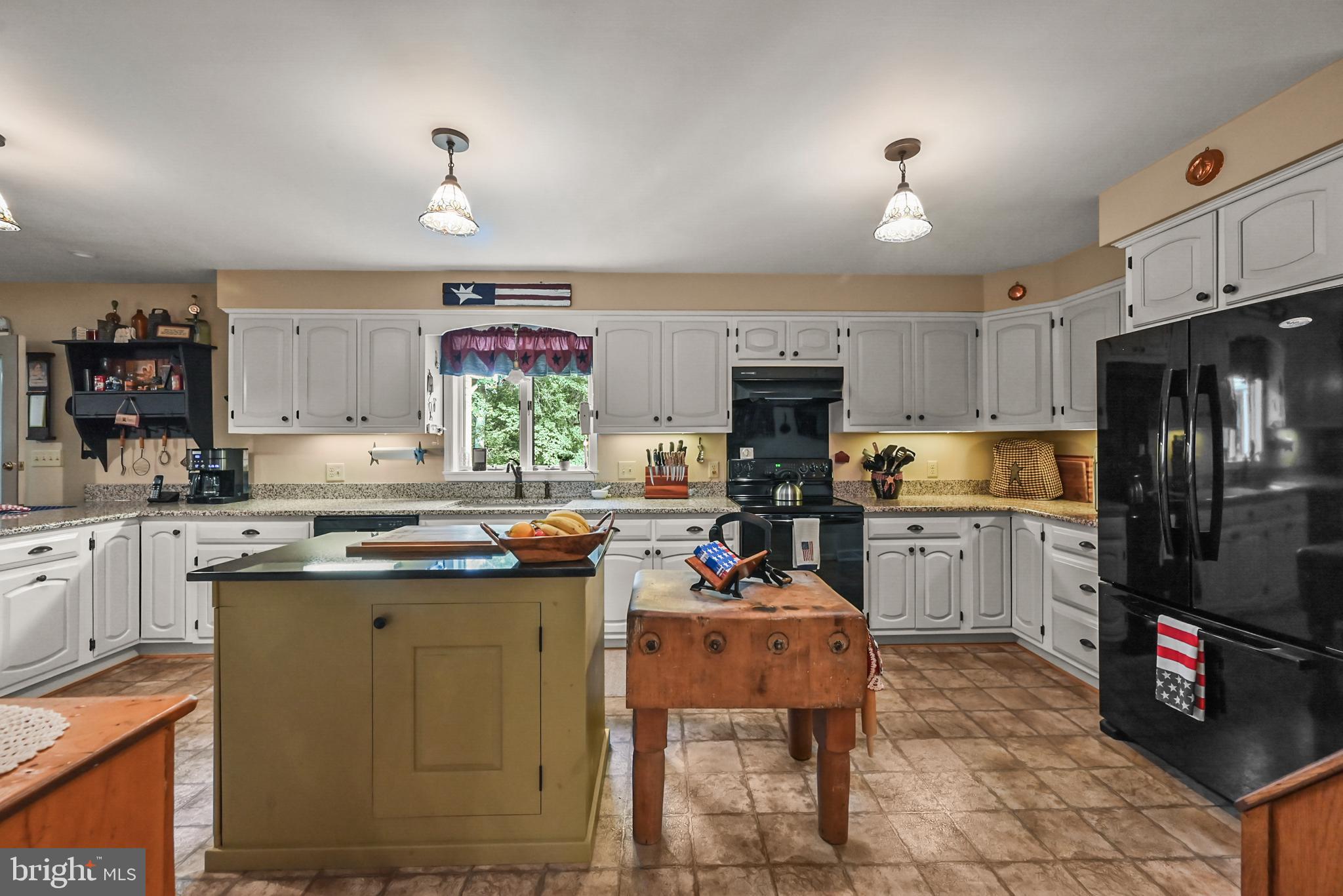 961 Beaver Creek Road Hanover, PA 17331 - Photo 10 of 52 a kitchen with a refrigerator a stove a sink a dining table and chairs