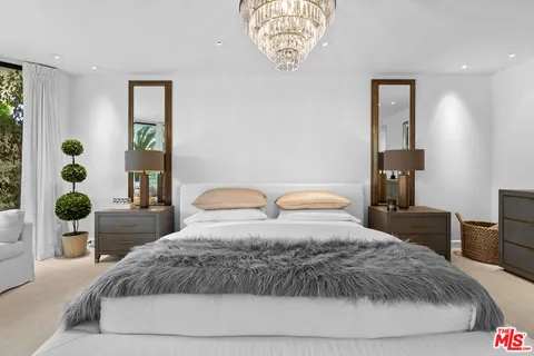 a bedroom with a large bed and a window