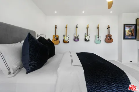a view of a patio with couches table and chairs under an umbrella
