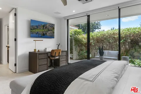 a view of a patio with a table chairs and a backyard