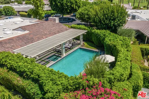 a view of a patio with a dining table and chairs with wooden floor and fence
