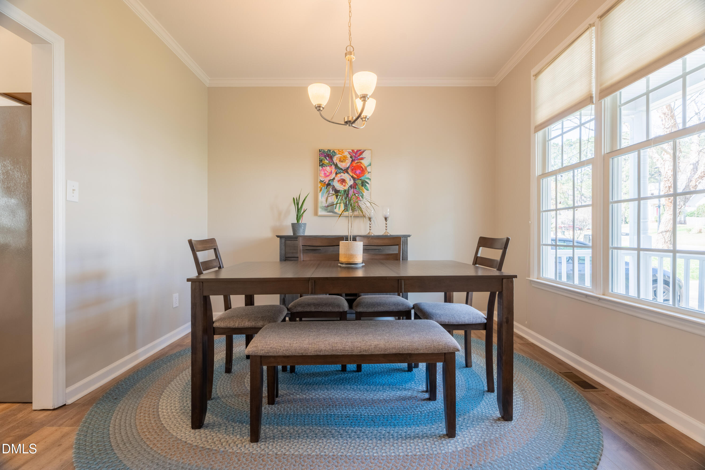1305 Olde Walker Mill Road Apex, NC 27502 - Photo 12 of 41 a view of a dining room with furniture wooden floor and a chandelier