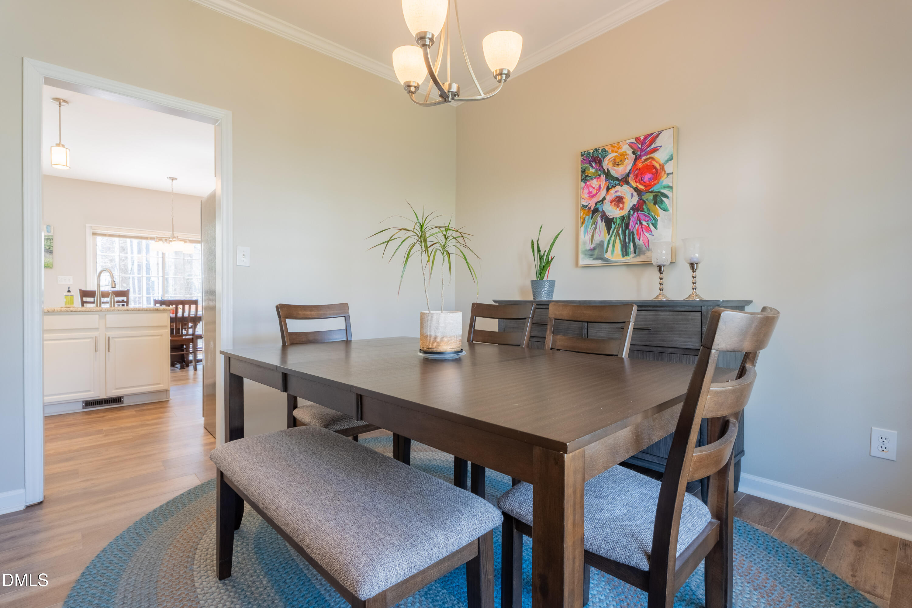 1305 Olde Walker Mill Road Apex, NC 27502 - Photo 13 of 41 a view of a dining room with furniture and wooden floor