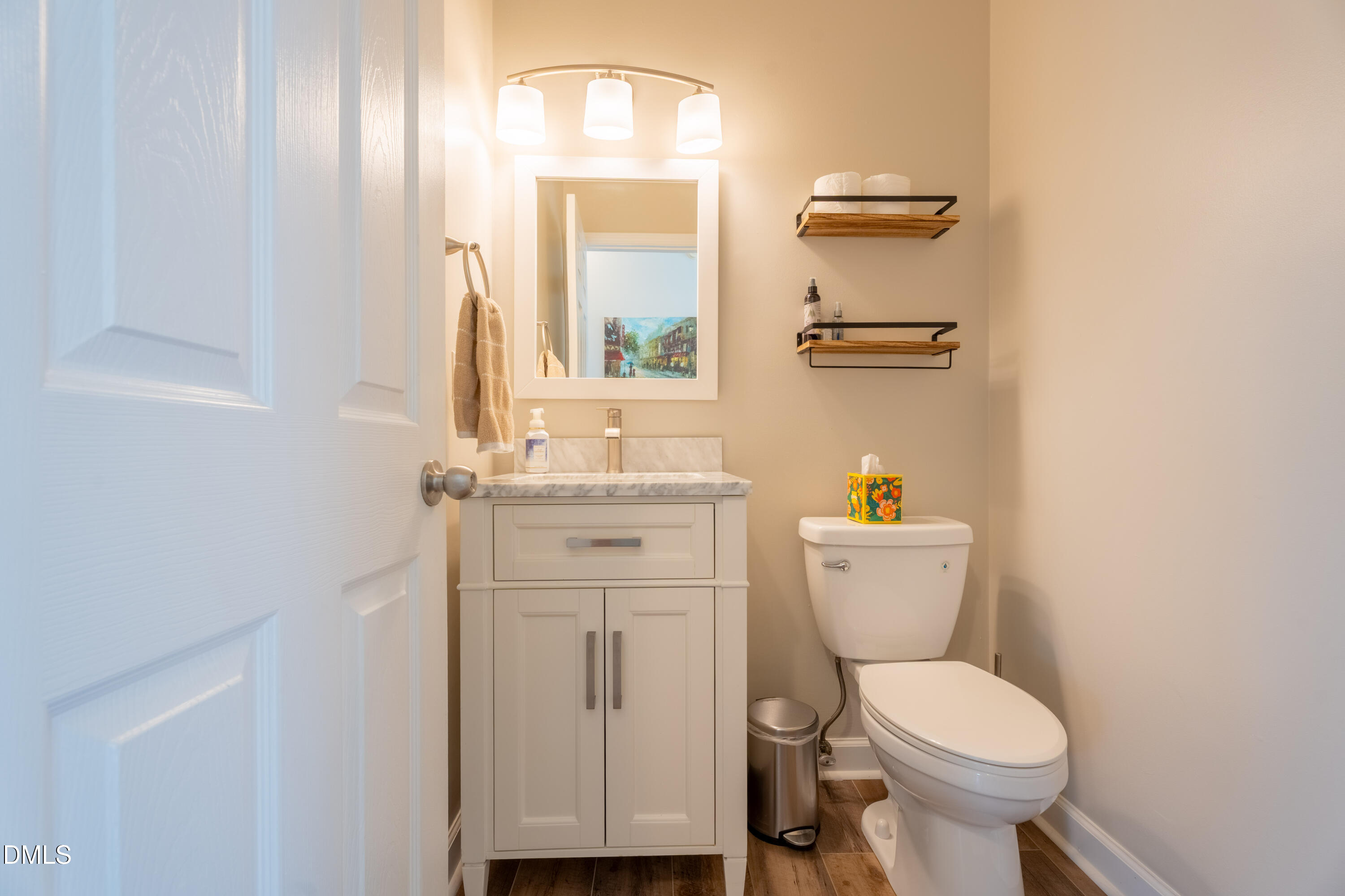 1305 Olde Walker Mill Road Apex, NC 27502 - Photo 14 of 41 a bathroom with a toilet a sink and mirror