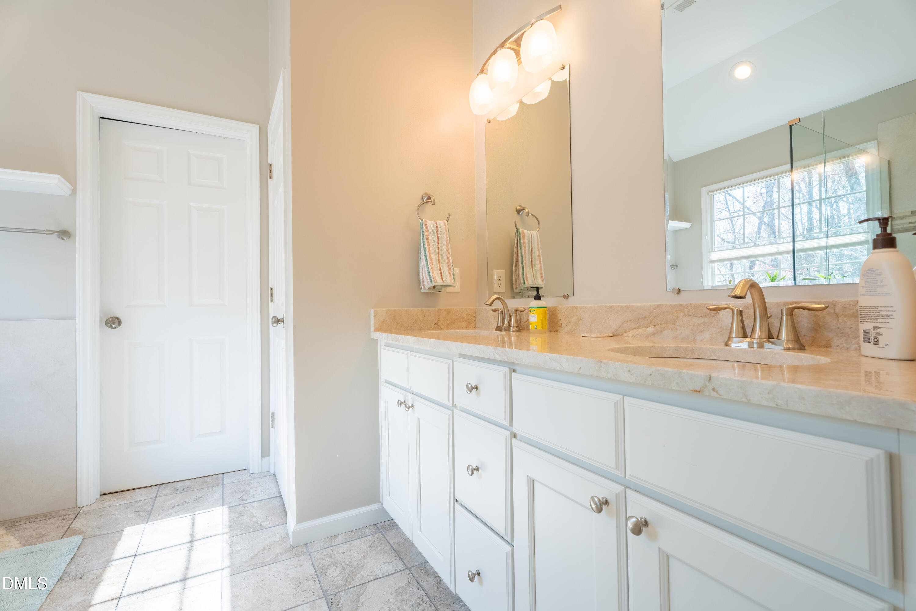 1305 Olde Walker Mill Road Apex, NC 27502 - Photo 23 of 41 a bathroom with a double vanity sink and a mirror