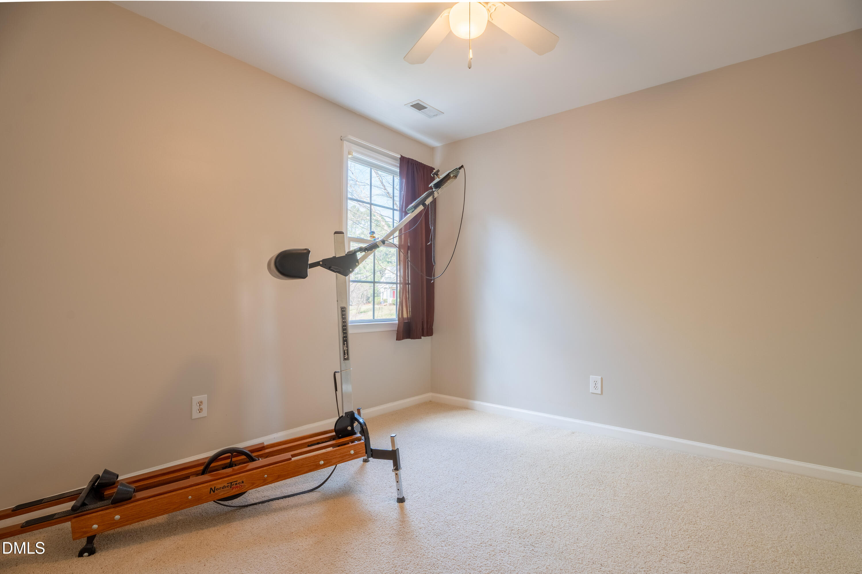 1305 Olde Walker Mill Road Apex, NC 27502 - Photo 27 of 41 a room with gym equipment and a chandelier
